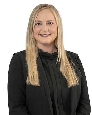 Head and shoulders photo of Heather Murray with long blond hair wearing a black blouse.