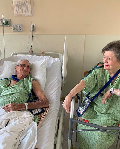 Earl and Marrianne sit in recovery room together after Watchman procedure.