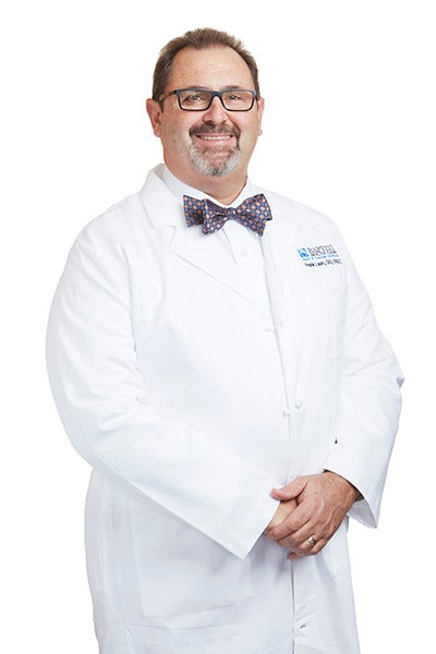 Dr. Lauro wearing white coat and bow tie