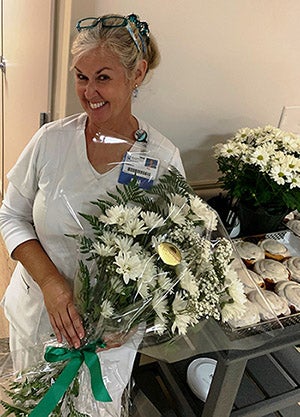 Photo of TK Hodges with daisy bouquet