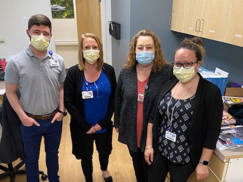 Baptist Medical Park - Navarre registration team members pose for camera.