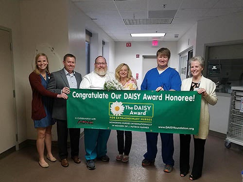 Gulf Breeze Hospital Nurse Presented with DAISY award from team members.