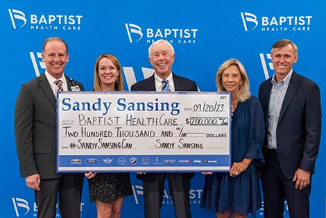 Sandy Sansing, Mark Faulkner, KC Gartman posing with big check
