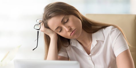 Tired woman falling asleep at her desk