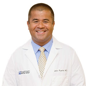 Dr. Jairo Puente in white coat