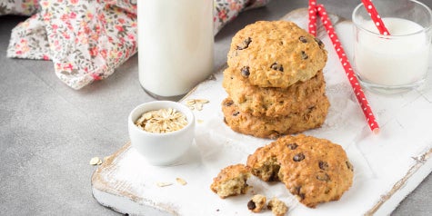 banana oatmeal chocolate chip cookies on a tray with milk