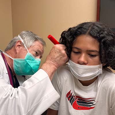 A doctor examining a child.