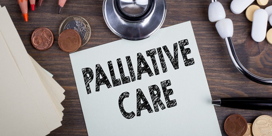 The words Palliative Care are written and surrounded by office supplies and medical equipment