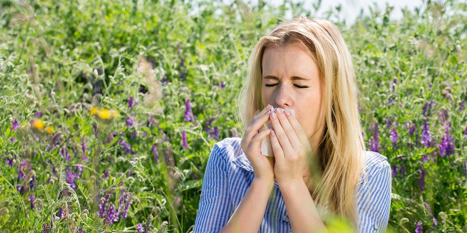Woman sneezing due to outdoor allergies