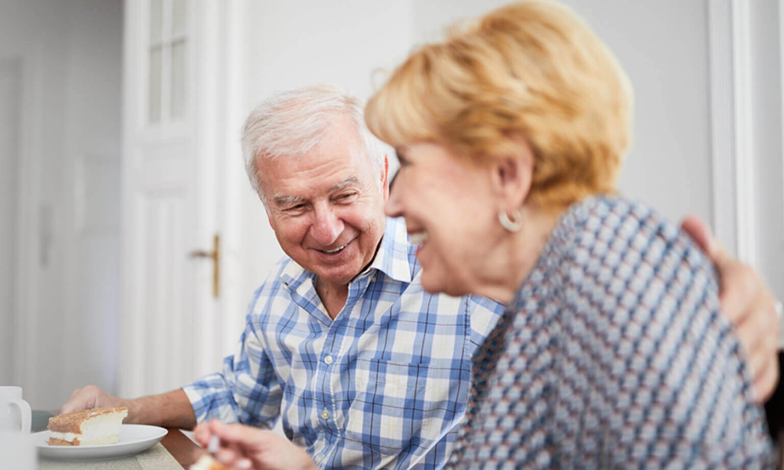 Elderly Couple smiling Eating Cake