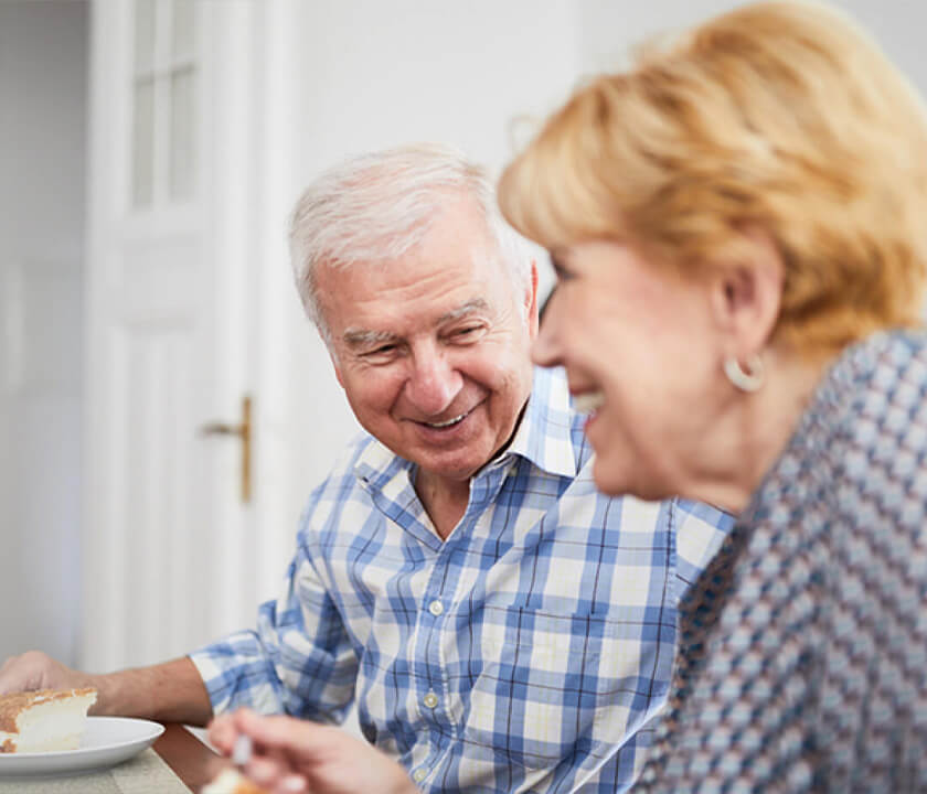 Elderly Couple smiling Eating Cake