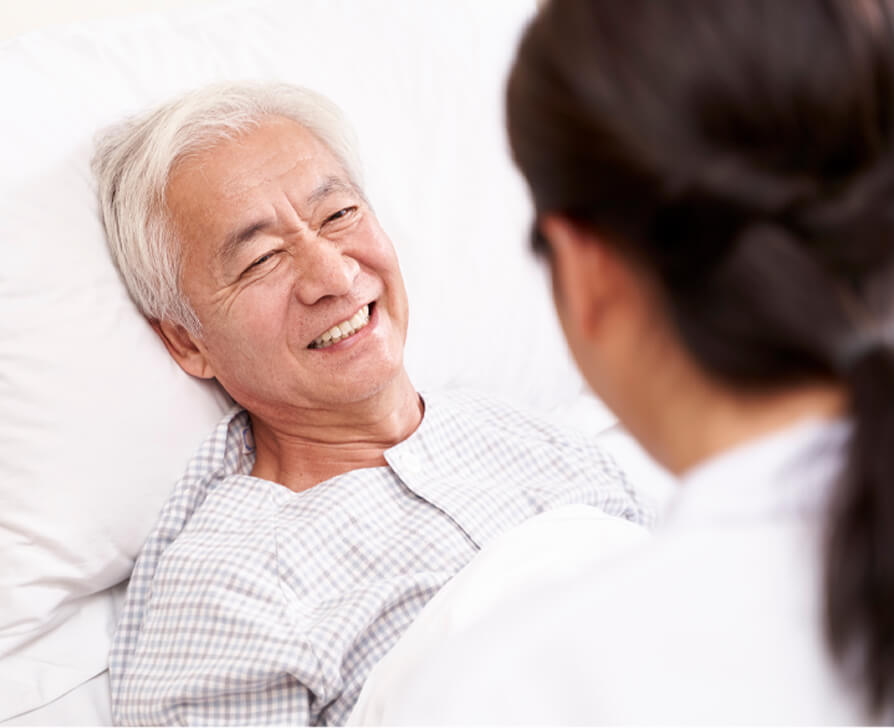 patient smiling on bed
