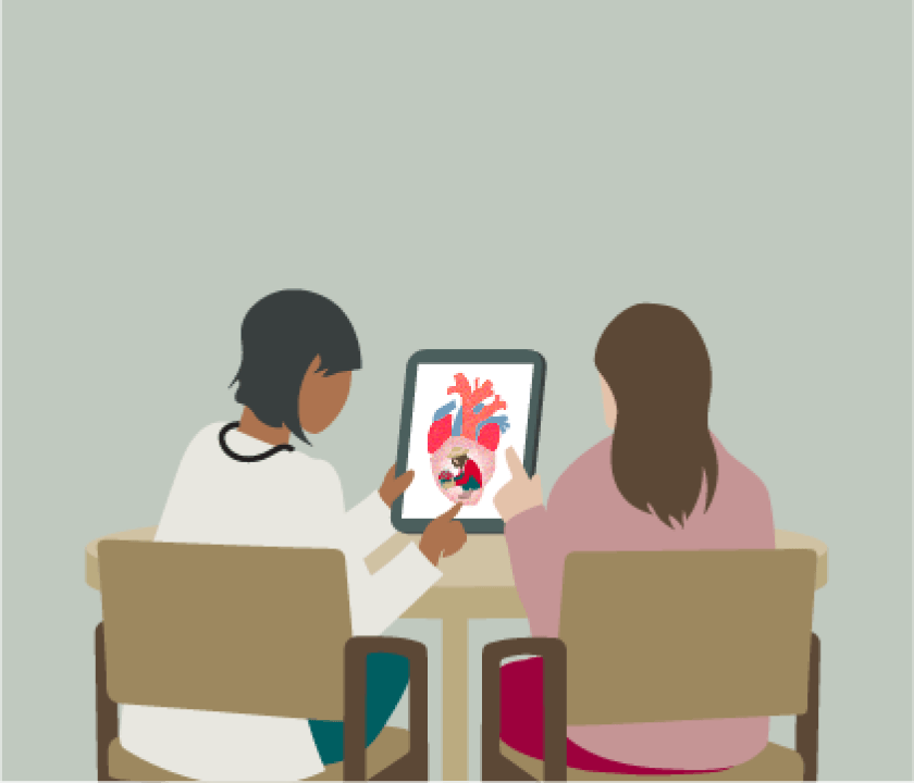 A doctor with a patient looking at the tablet