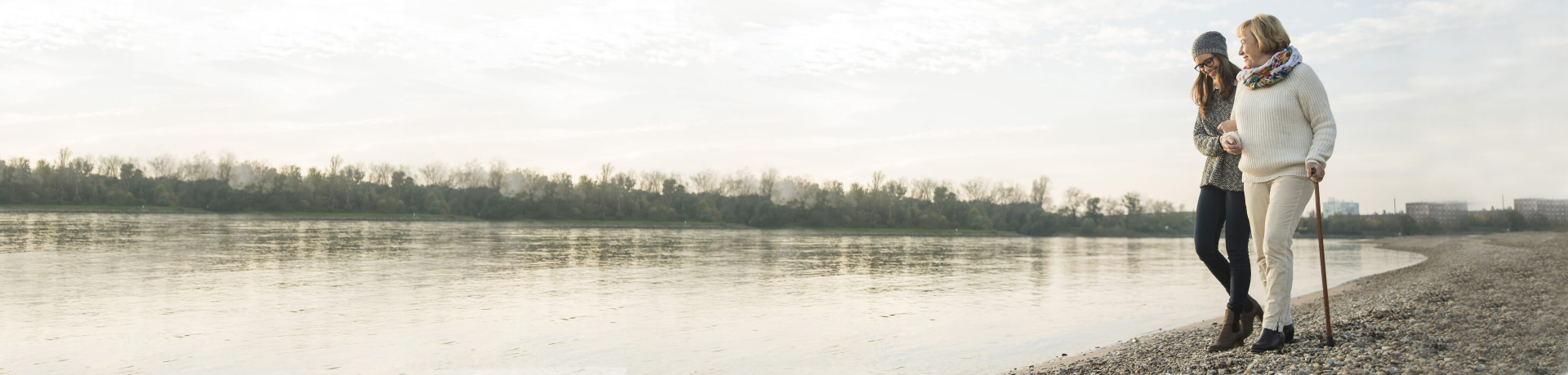 Mother and daughter walking along beach