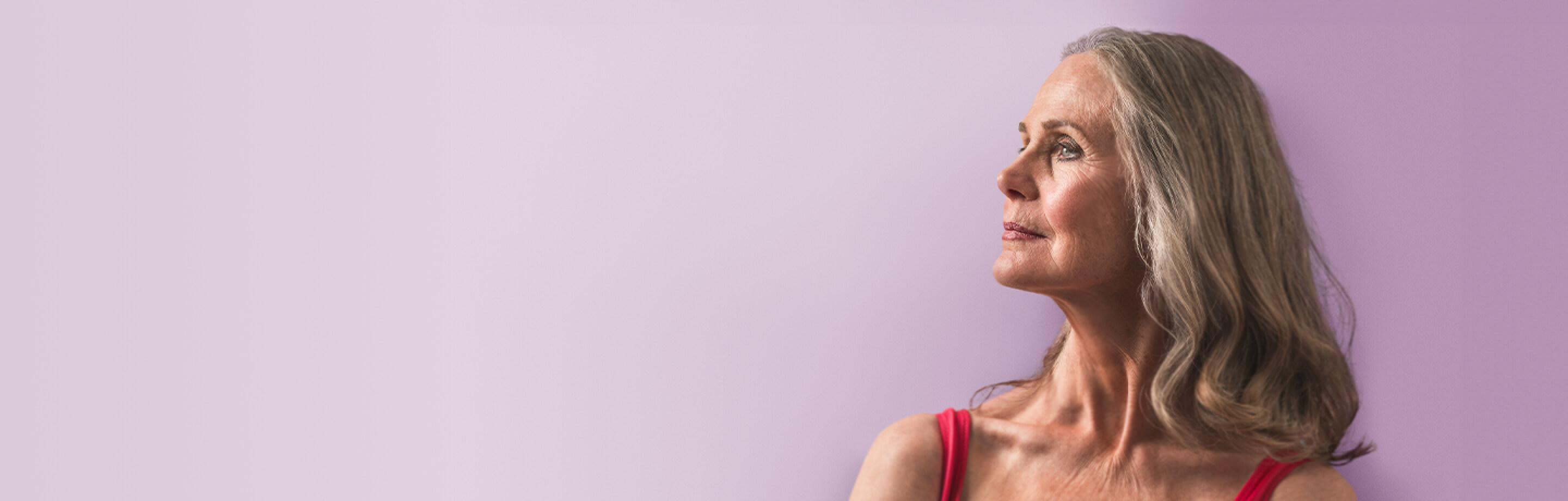 Woman looking to the left with a purple backdrop