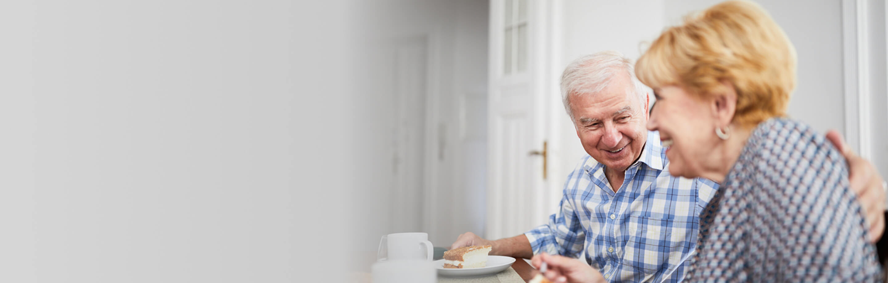 Elderly Couple smiling Eating Cake