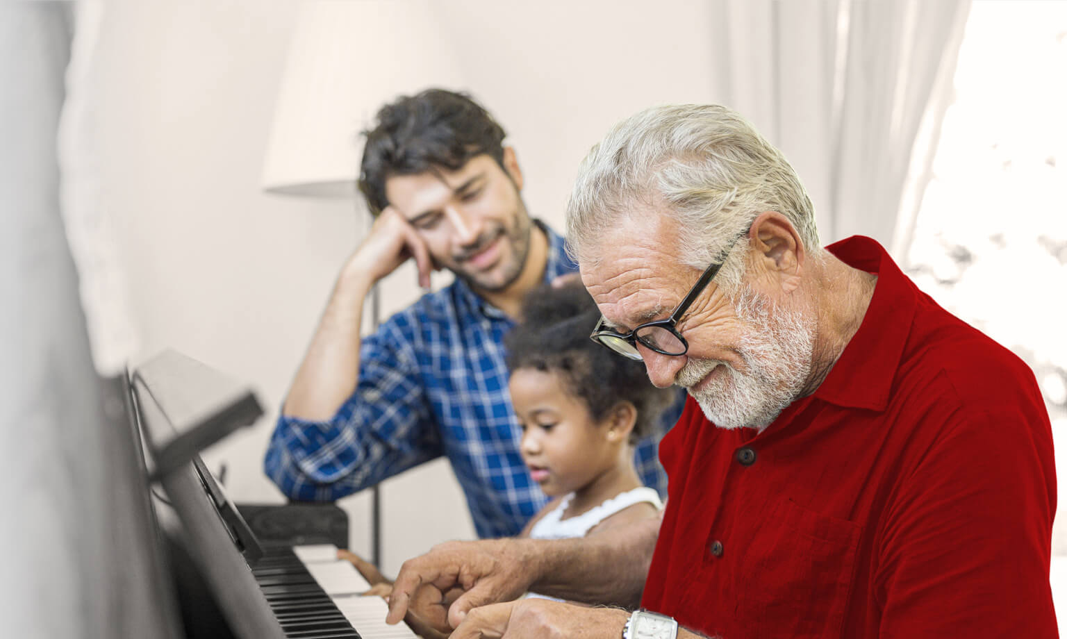 Old man playing piano for his grand children
