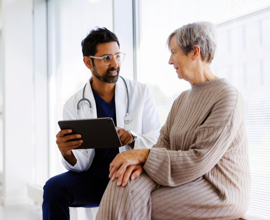 Dr with tablet consulting with patient