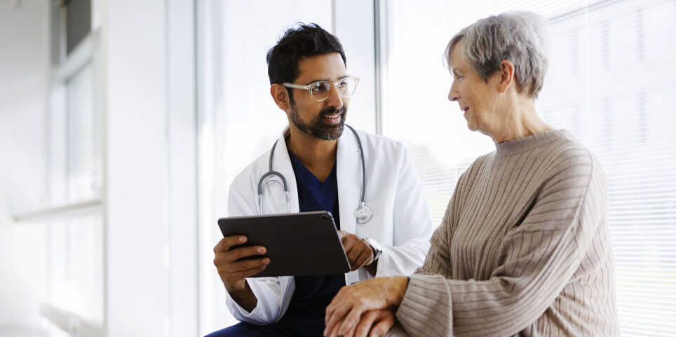 Doctor Consulting Patient with Tablet