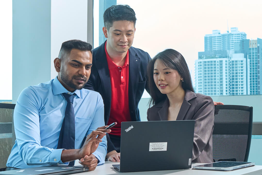 Coworkers in front of a laptop