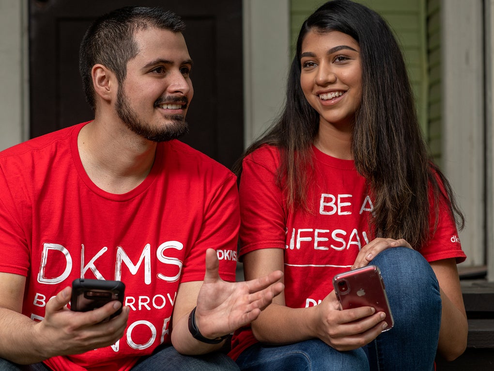 People with smartphones about to register as a donor People with smartphones about to register as a donor