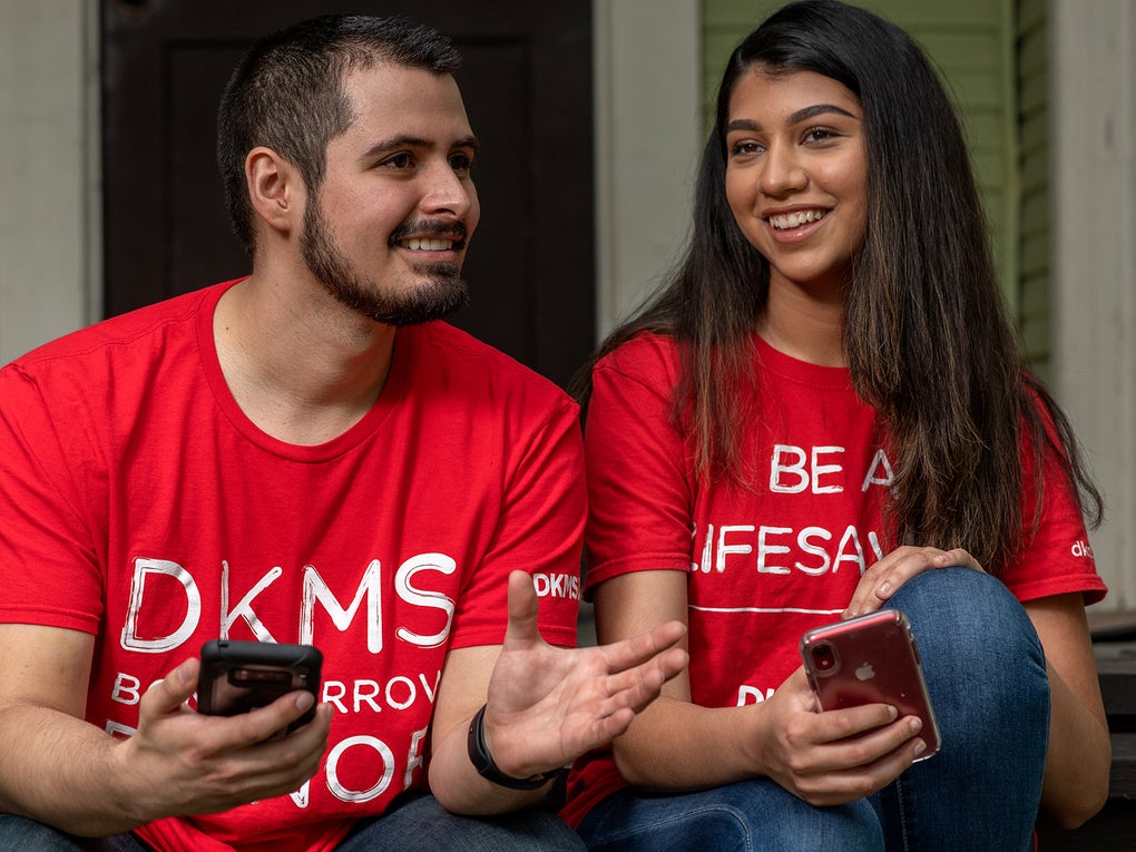 People with smartphones about to register as a donor People with smartphones about to register as a donor