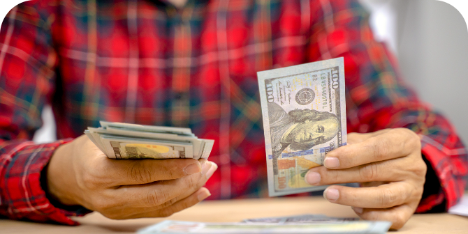 Money Order Counting out cash to send in a money order at CheckSmart.