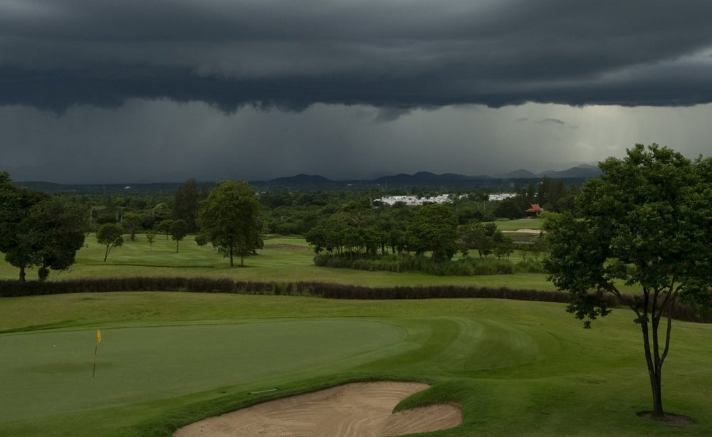 Aerial view of a golf course on a stormy day.