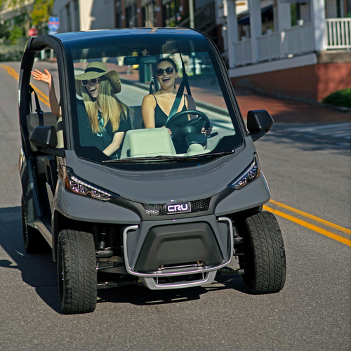 Two women drive the street legal Club Car CRU
