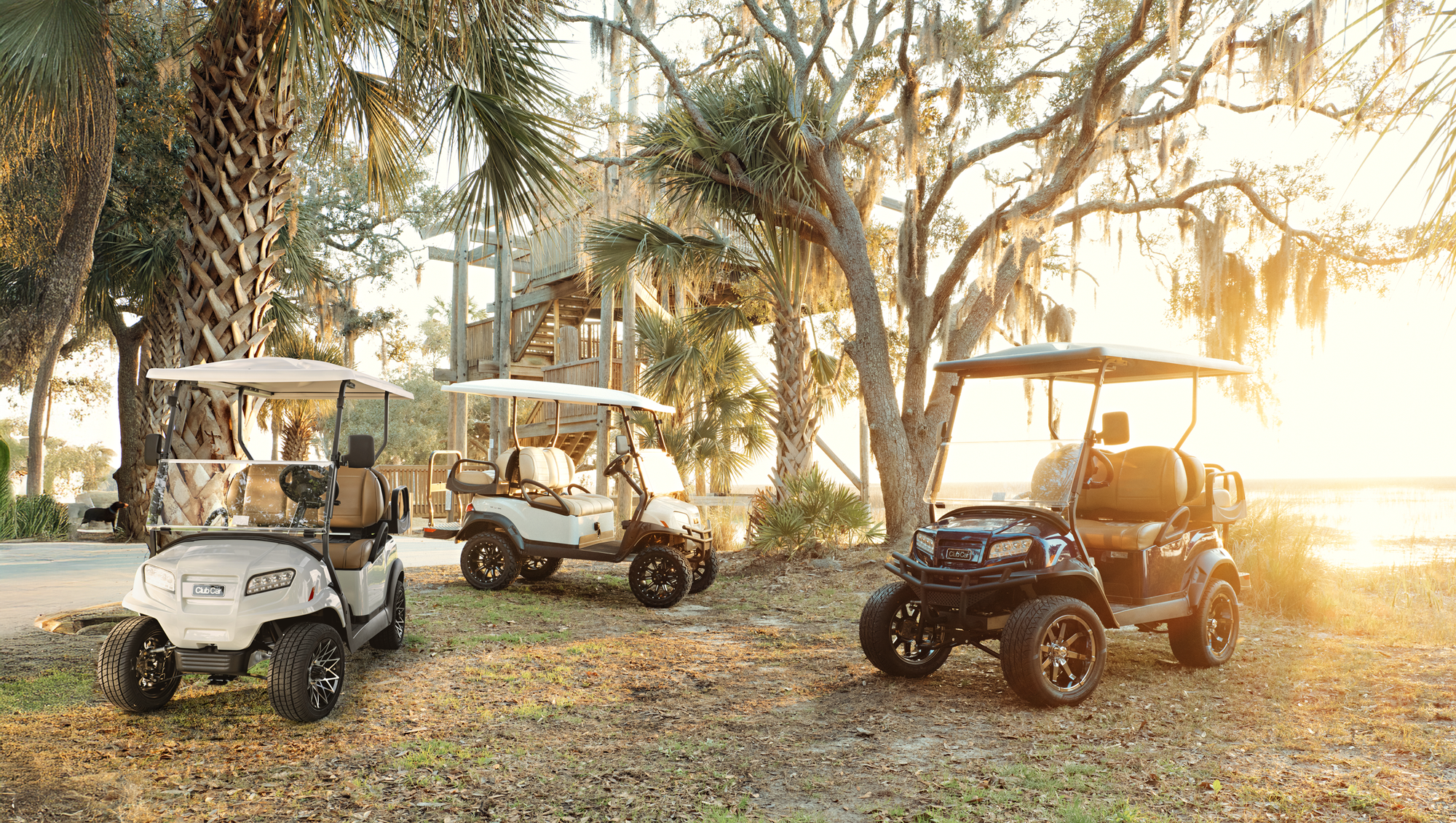 3 Club Car Onward® vehicles are parked outside. 