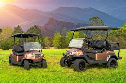 Two special edition Sunrise golf carts parked in the grass