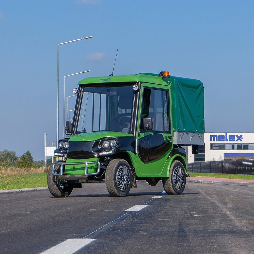 A Melex utility vehicle is parked on a street outside the Melex plant.