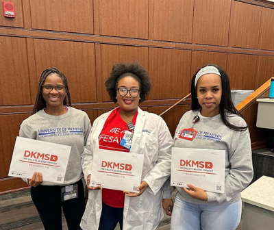 Three students from The University of Memphis Student Nursing Association holding DKMS packets Three students from The University of Memphis Student Nursing Association holding DKMS packets