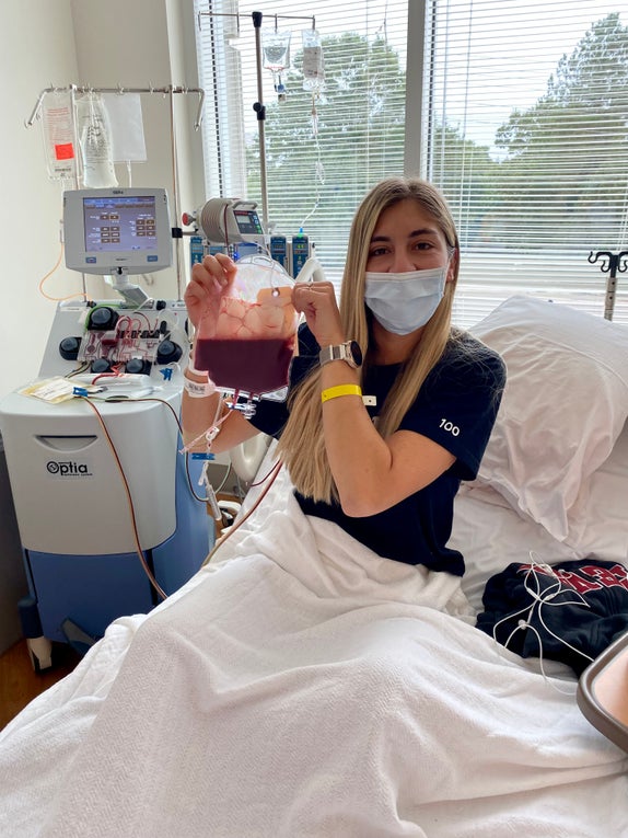 Alanna smiling under her mask holding her stem cell donation Alanna smiling under her mask holding her stem cell donation