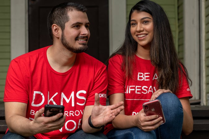People with smartphones about to register as a donor People with smartphones about to register as a donor