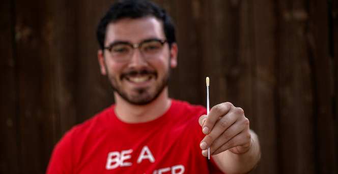 Guy holding swab DKMS Guy holding swab DKMS