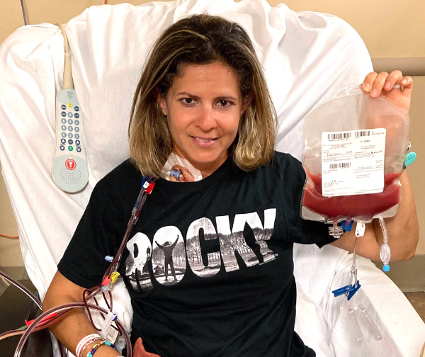 DKMS donor Alyson holding her stem cell donation bag