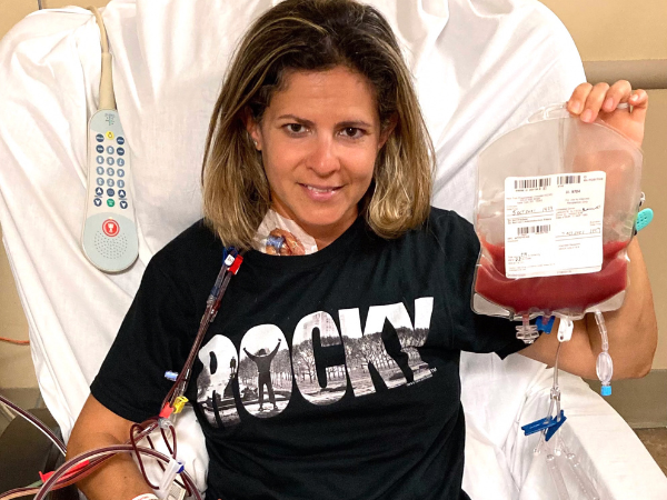 DKMS donor Alyson holding her stem cell donation bag