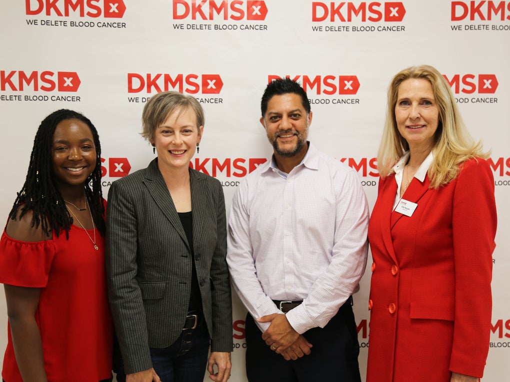 DKMS stem cell donor, Jasmine Thompson, Transplant recipient, Kristi Martin, Transplant Physician, Dr. Nilay Shah, and DKMS Global CEO, Dr. Elke Neujahr standing in front of a DKMS logo banner at the Charlotte Media event. DKMS stem cell donor, Jasmine Thompson, Transplant recipient, Kristi Martin, Transplant Physician, Dr. Nilay Shah, and DKMS Global CEO, Dr. Elke Neujahr standing in front of a DKMS logo banner at the Charlotte Media event.
