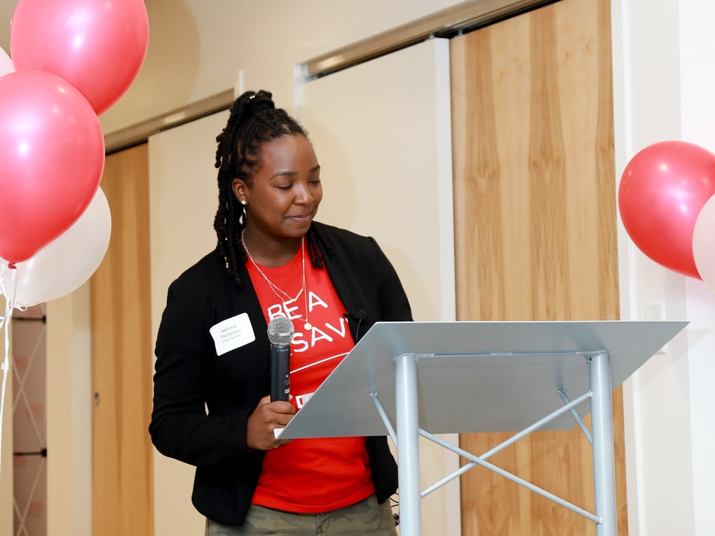 DKMS Donor, Jasmine Deberry Thompson, sharing her story at the podium. DKMS Donor, Jasmine Deberry Thompson, sharing her story at the podium.