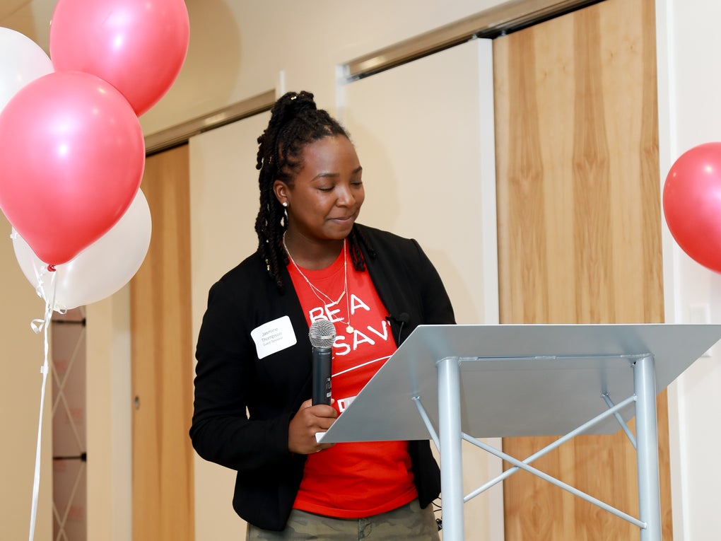DKMS Donor, Jasmine Deberry Thompson, sharing her story at the podium. DKMS Donor, Jasmine Deberry Thompson, sharing her story at the podium.
