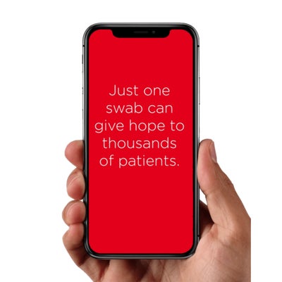 Hand holding a phone with a red background and white text reading, "Just one swab can give hope to thoughts of patients."
