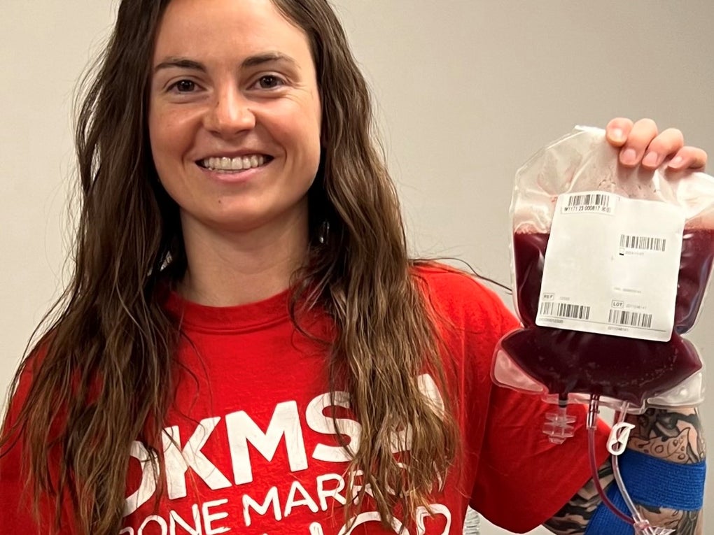 DKMS donor, Aimee, holding her stem cells in her DKMS donor shirt DKMS donor, Aimee, holding her stem cells in her DKMS donor shirt