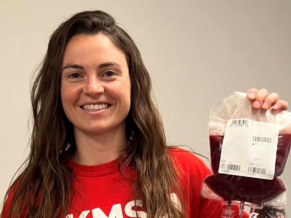 DKMS donor, Aimee, holding her stem cells in her DKMS donor shirt DKMS donor, Aimee, holding her stem cells in her DKMS donor shirt