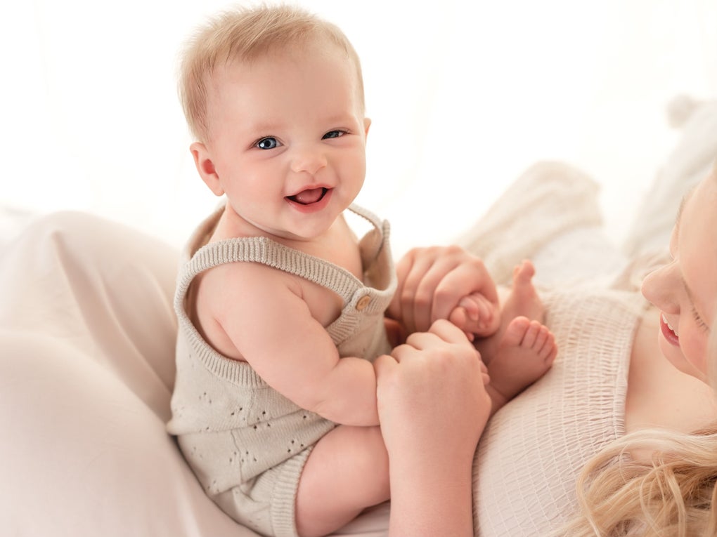 DKMS patient, Clementine, sitting on her mom's lap and smiling. DKMS patient, Clementine, sitting on her mom's lap and smiling.