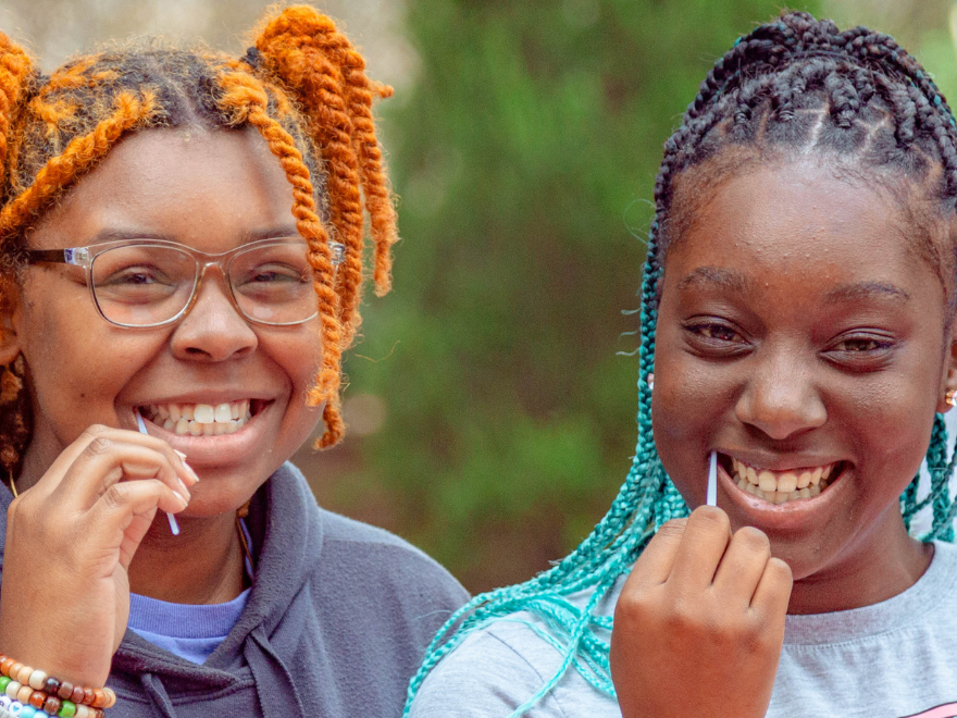Two girls swabbing to become a blood stem donor with DKMS Two girls swabbing to become a blood stem donor with DKMS