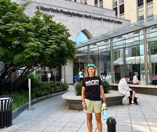Alyson standing out front of New York Presbyterian Weill Cornell Medical Center