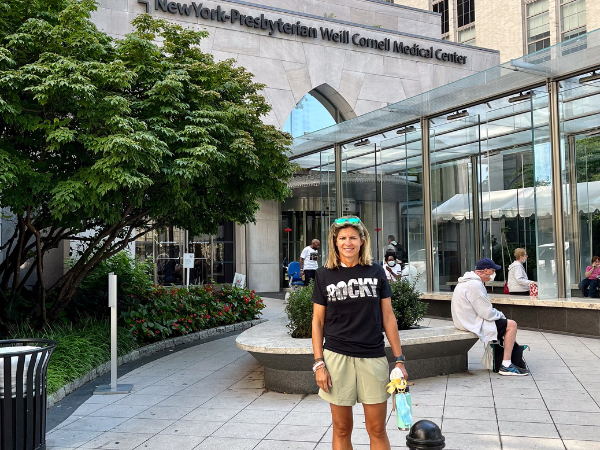 Alyson standing out front of New York Presbyterian Weill Cornell Medical Center
