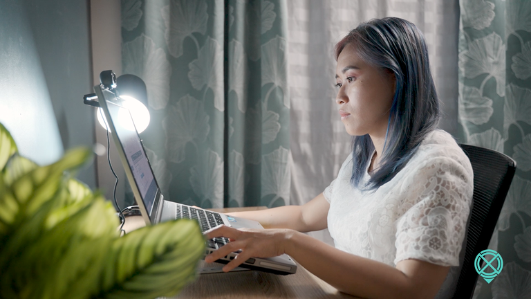 Junette at her computer typing