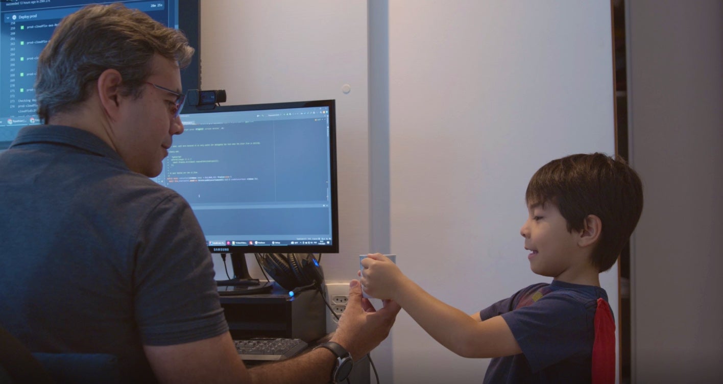 Fabiano at his home office with his son.